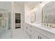 Luxury bathroom featuring double sinks, elegant fixtures, and a view into a well-appointed bedroom at 152 Riggings Way, Clermont, FL 34711