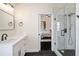 Modern bathroom featuring a sleek vanity, a glass-enclosed shower, and views into an adjacent bedroom at 152 Riggings Way, Clermont, FL 34711
