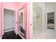 Bathroom with modern glass shower, pink walls, and view into an adjacent bedroom at 152 Riggings Way, Clermont, FL 34711
