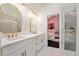 Bathroom with double sinks, quartz countertop, and gold fixtures with a view to the bedroom at 152 Riggings Way, Clermont, FL 34711