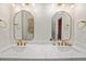 Bright bathroom featuring double vanity, gold fixtures, and modern mirrors at 152 Riggings Way, Clermont, FL 34711