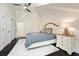 A bedroom with dark wood floors, sloped ceilings, a cozy bed, and a ceiling fan, perfect for relaxing at 152 Riggings Way, Clermont, FL 34711