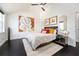 Bright bedroom featuring a ceiling fan, dark floors and neutral decor at 152 Riggings Way, Clermont, FL 34711