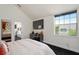 Bright bedroom featuring ceiling fan, view and en suite bath at 152 Riggings Way, Clermont, FL 34711