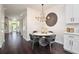 Bright dining area with modern chandelier, round table, and hardwood floors at 152 Riggings Way, Clermont, FL 34711