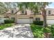 Inviting two-story townhome with a well-maintained front yard and a two-car garage at 152 Riggings Way, Clermont, FL 34711
