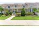Charming two-story townhome with inviting front porch and manicured landscaping, including bushes and a well-maintained lawn at 152 Riggings Way, Clermont, FL 34711