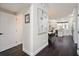 Hallway view leading to a bright, modern kitchen with white cabinets at 152 Riggings Way, Clermont, FL 34711