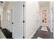 Hallway with white walls, dark trim, and a view of multiple doors at 152 Riggings Way, Clermont, FL 34711