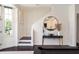 Hallway with dark floors leading to the staircase and a glimpse of the living area at 152 Riggings Way, Clermont, FL 34711