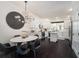Modern kitchen with a dining area featuring an elegant chandelier and dark hardwood floors at 152 Riggings Way, Clermont, FL 34711