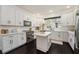 Bright kitchen with white cabinets, an island, and stainless steel appliances at 152 Riggings Way, Clermont, FL 34711