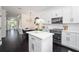 Modern kitchen featuring white cabinets, stainless steel appliances, and a kitchen island at 152 Riggings Way, Clermont, FL 34711