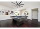 Bright living room features hardwood floors, recessed lighting, a modern pool table, and stylish artwork at 152 Riggings Way, Clermont, FL 34711