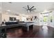 Bright living room features hardwood floors, a stylish pool table, recessed lights, and access to the front door at 152 Riggings Way, Clermont, FL 34711