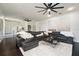 Open-concept living room featuring dark wood floors, a comfortable sectional sofa, and modern decor at 152 Riggings Way, Clermont, FL 34711
