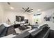 Spacious living room with dark wood floors, comfortable seating, and a modern entertainment center at 152 Riggings Way, Clermont, FL 34711