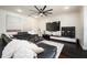 Stylish living room with a large sectional sofa, modern art, and a sleek entertainment center at 152 Riggings Way, Clermont, FL 34711