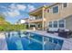 Beautiful backyard with pool, spa, outdoor kitchen and dining, and living area at 15769 Shorebird Ln, Winter Garden, FL 34787