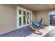 Relaxing balcony features a hammock, providing a peaceful retreat with views through sliding glass doors at 15769 Shorebird Ln, Winter Garden, FL 34787