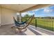 A covered balcony with a comfortable hammock offers relaxing outdoor space with scenic green lawn views at 15769 Shorebird Ln, Winter Garden, FL 34787