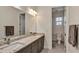 Bathroom featuring a double sink vanity with granite countertops, modern fixtures, and a separate toilet area at 15769 Shorebird Ln, Winter Garden, FL 34787