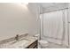 Bathroom featuring a single sink with granite countertops, a framed mirror, and a shower with a curtain at 15769 Shorebird Ln, Winter Garden, FL 34787
