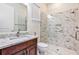 Bright bathroom with granite counters, a glass-enclosed shower with marble tile, and modern fixtures and finishes at 15769 Shorebird Ln, Winter Garden, FL 34787