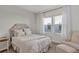 Stylishly decorated bedroom featuring a comfortable bed, elegant curtains, and abundant natural light at 15769 Shorebird Ln, Winter Garden, FL 34787