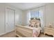 Bright bedroom features a twin bed, bedside table, with natural light streaming through a window at 15769 Shorebird Ln, Winter Garden, FL 34787
