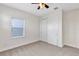 Neutral bedroom featuring carpeted floors, a window with blinds, a ceiling fan, and a closet with sliding doors at 15769 Shorebird Ln, Winter Garden, FL 34787
