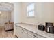 Countertop with coffee maker and toaster oven, with view of a living space in background at 15769 Shorebird Ln, Winter Garden, FL 34787