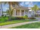 Beautiful two-story home with lush landscaping, covered porch with columns, and a two-car garage at 15769 Shorebird Ln, Winter Garden, FL 34787