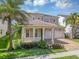 Stunning two-story home featuring tropical landscaping, a tile roof, covered porch, and a two-car garage at 15769 Shorebird Ln, Winter Garden, FL 34787