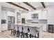 Kitchen features large island, granite countertops, stainless appliances, and wood beams at 15769 Shorebird Ln, Winter Garden, FL 34787