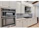 Kitchen features stainless steel oven and range hood, with custom white cabinetry at 15769 Shorebird Ln, Winter Garden, FL 34787