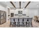 Kitchen with large island, white cabinets, wood beams, and stainless steel appliances at 15769 Shorebird Ln, Winter Garden, FL 34787