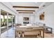 Bright living room with wood beam ceiling, fireplace, large sliding glass doors, and tile floors at 15769 Shorebird Ln, Winter Garden, FL 34787
