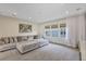 Spacious living room with a large sectional sofa, media equipment, and natural lighting at 15769 Shorebird Ln, Winter Garden, FL 34787