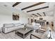 Spacious living room featuring wood beam ceiling, tile floors, neutral paint, and open floor plan at 15769 Shorebird Ln, Winter Garden, FL 34787