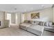 Neutral living room features a large, comfortable sectional and access to multiple doors and hallways at 15769 Shorebird Ln, Winter Garden, FL 34787