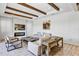 Elegant living room featuring a fireplace, wood beam ceiling, tile floors, and neutral decor at 15769 Shorebird Ln, Winter Garden, FL 34787