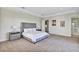 Bright main bedroom with neutral colors, carpeted floors, and access to the ensuite bathroom at 15769 Shorebird Ln, Winter Garden, FL 34787