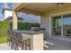Outdoor kitchen with bar seating overlooking the backyard at 15769 Shorebird Ln, Winter Garden, FL 34787