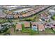 Expansive aerial view of a planned community with single-Gathering homes, pools, and scenic water features at 1640 Oak Blossom Dr, Davenport, FL 33837