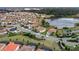 Overhead view showcasing homes with pools and landscaping in a lakeside community at 1640 Oak Blossom Dr, Davenport, FL 33837