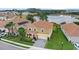 An aerial view shows a beautiful home close to a lake and other houses in a lovely neighborhood at 1640 Oak Blossom Dr, Davenport, FL 33837