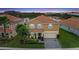 A serene aerial view shows a beautiful home adjacent to a serene lake in a vibrant community at 1640 Oak Blossom Dr, Davenport, FL 33837