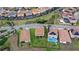 An aerial perspective showcases neighboring houses, complemented by amenities such as a play area and a swimming pool at 1640 Oak Blossom Dr, Davenport, FL 33837