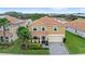 Beautiful aerial view of a well-maintained home featuring a brick-paved driveway and near a serene lake at 1640 Oak Blossom Dr, Davenport, FL 33837